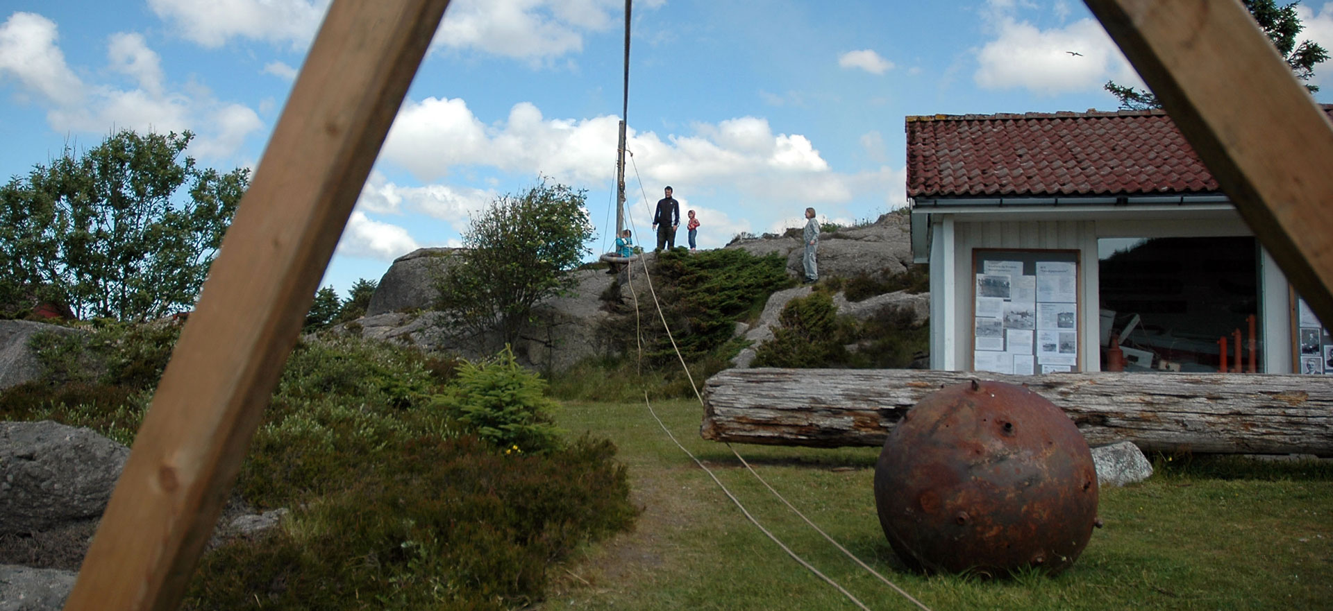 Museumsbygget i Varden sett utanfrå, med gamle gjenstandar frå sjøen i graset