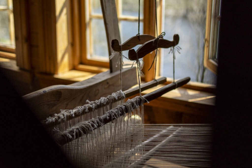 An old wool loom at an old sheeps farm now turned museum at Limagarden looking out on the tiny but scenic lake Limagarden